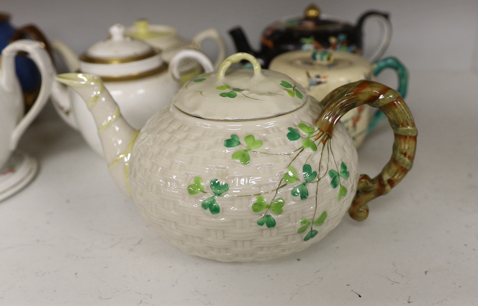 A quantity of various teapots including Belleek, Japanese Satsuma etc.